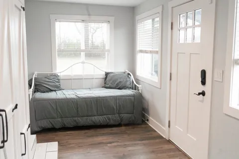 a bedroom with a bed and a window