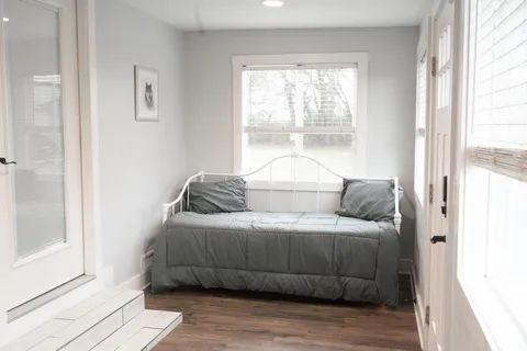 a bedroom with a bed and a window