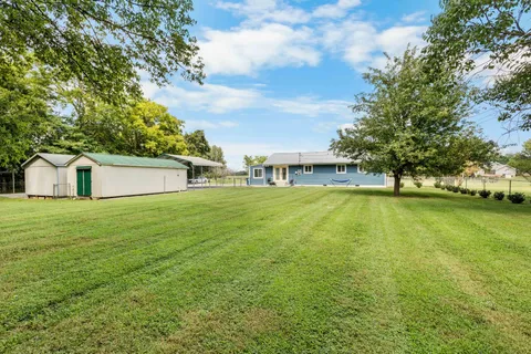 a house view with swimming pool in front of it