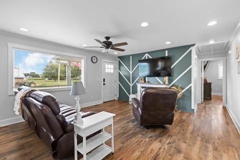 a living room with furniture and a floor to ceiling window