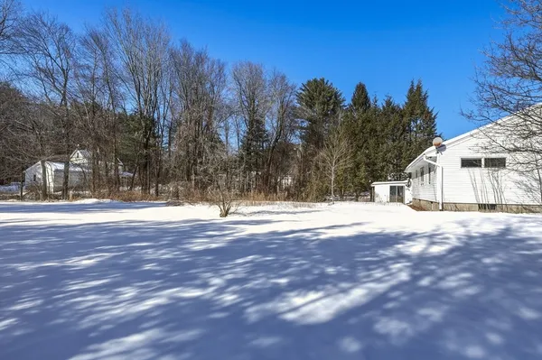 a view of a house with snow on the road