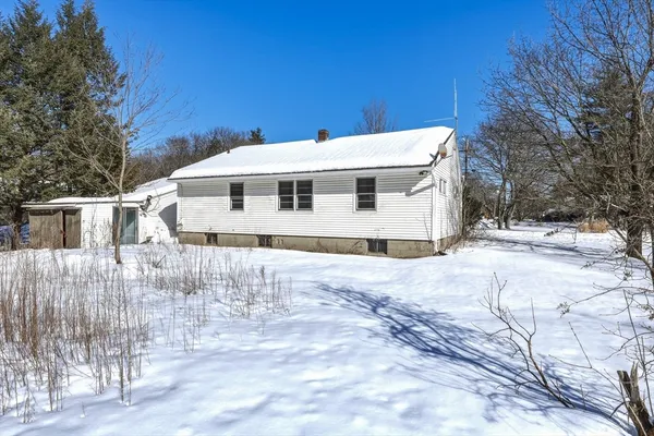a view of a white house with a yard