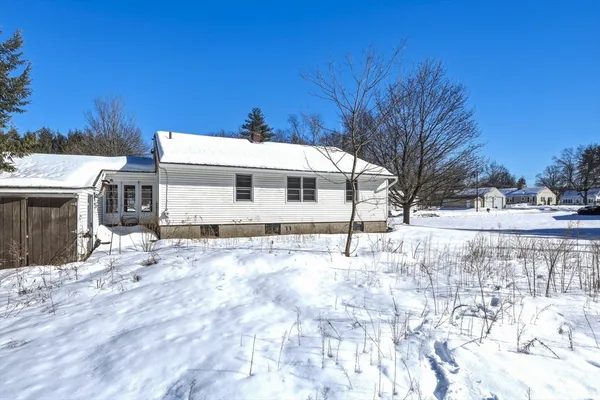 a view of a house with snow on the road