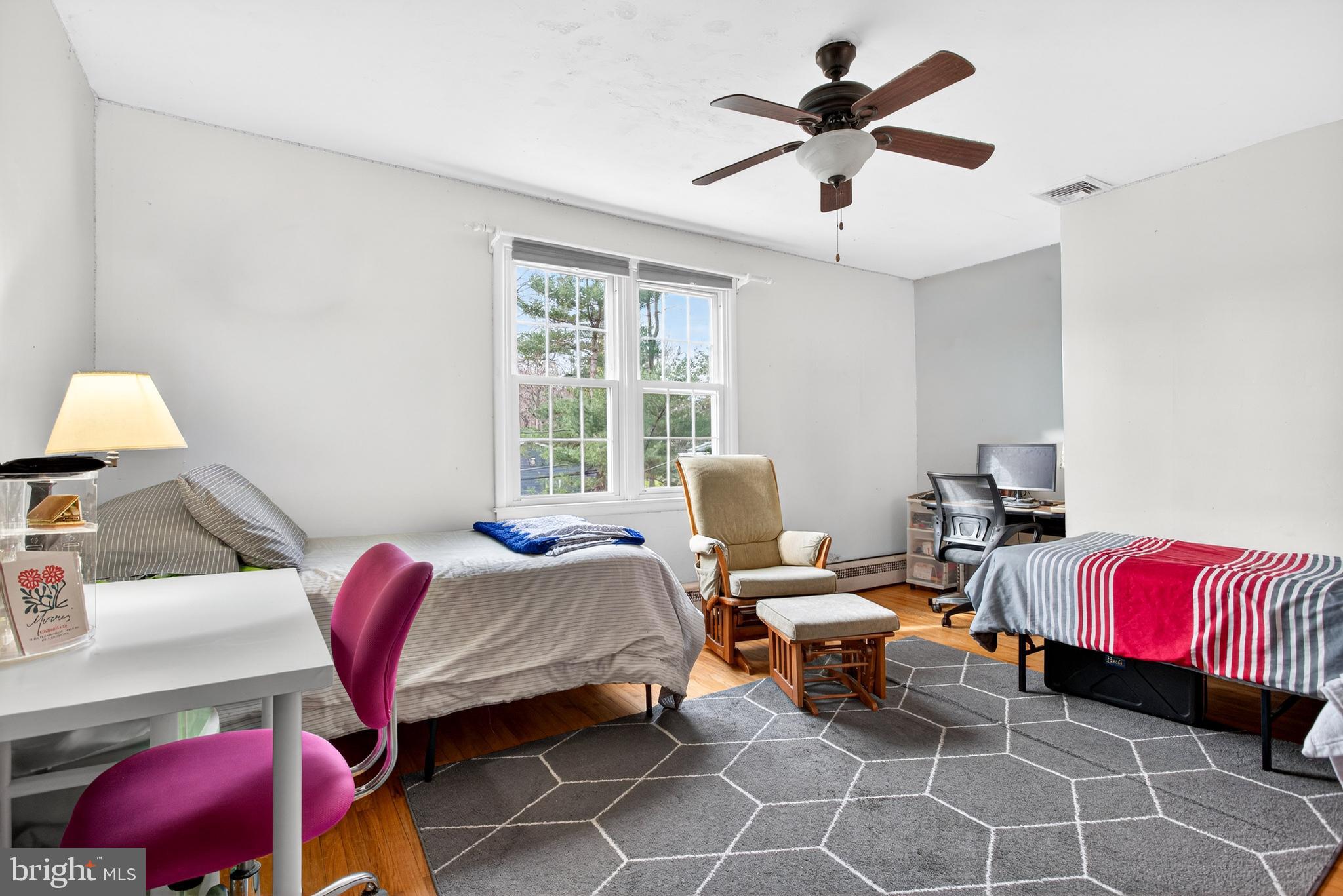 26 Austin Road Yardley, PA 19067 - Photo 16 of 33 a bedroom with a bed and a chandelier