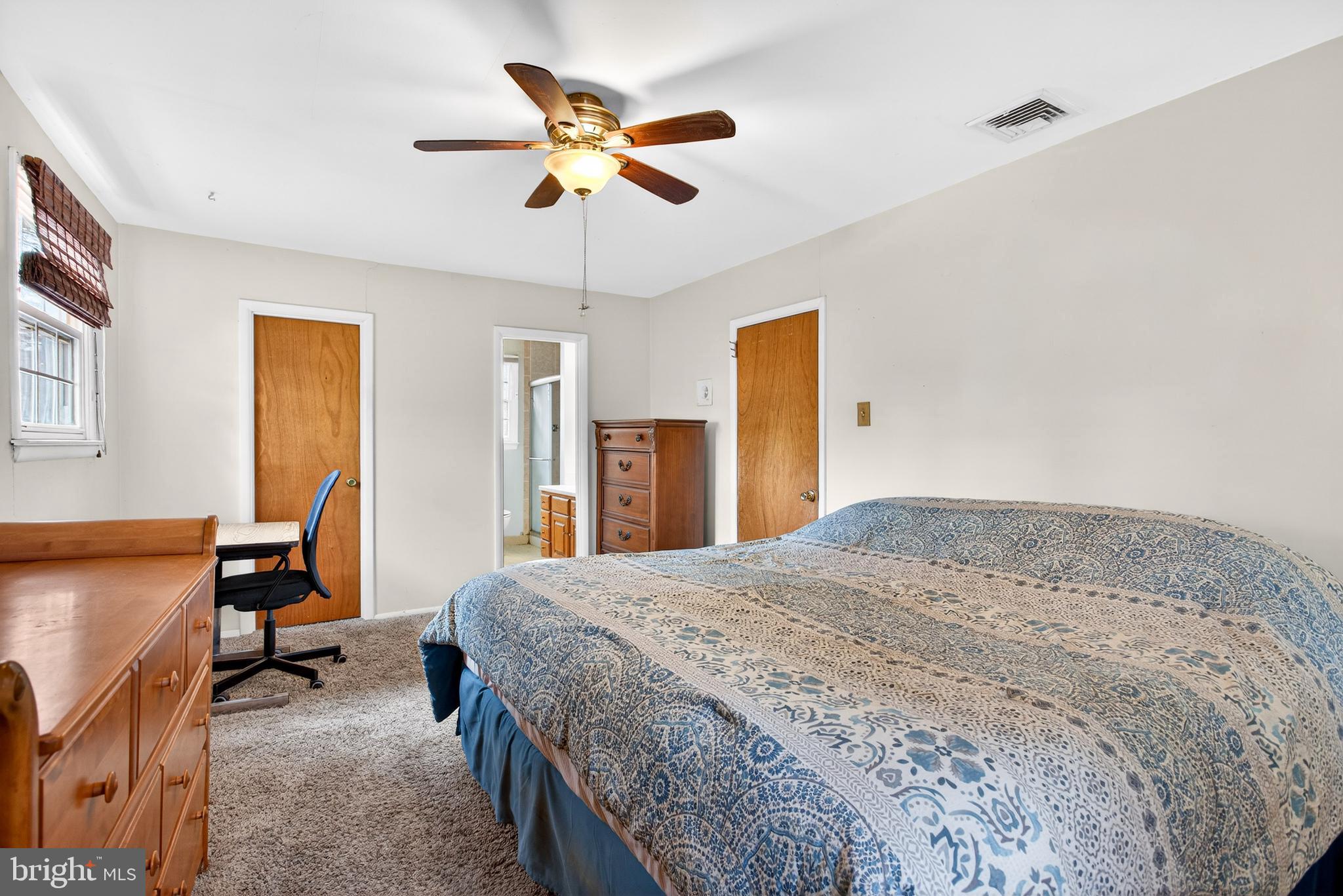 26 Austin Road Yardley, PA 19067 - Photo 23 of 33 a spacious bedroom with a bed and a chandelier