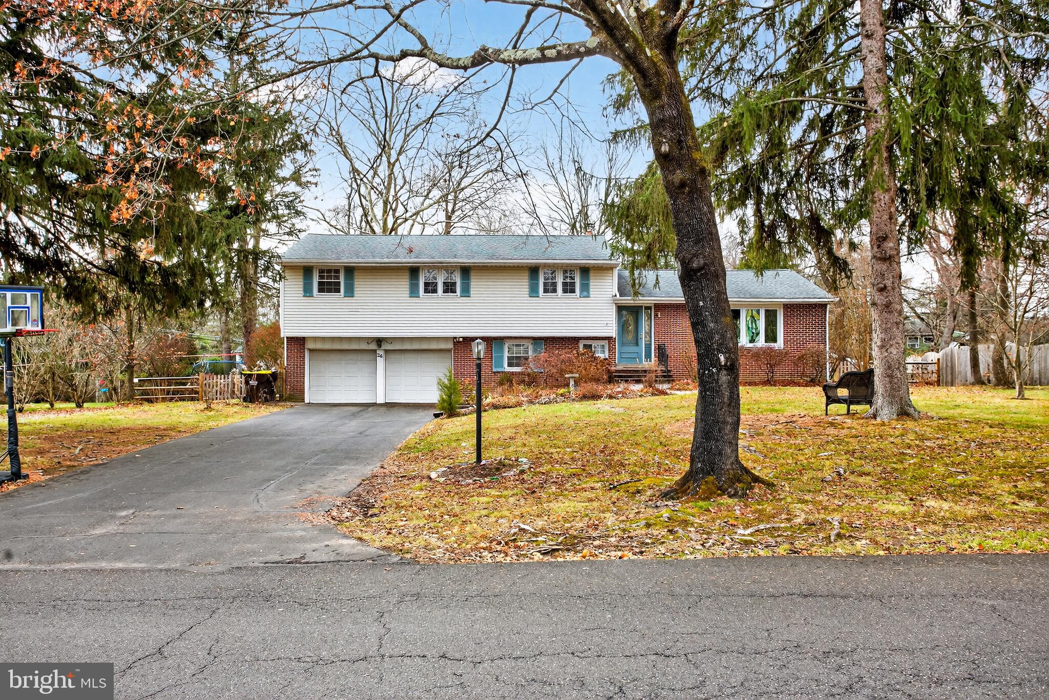 26 Austin Road Yardley, PA 19067 - Photo 33 of 33 a front view of a house with a yard covered with trees