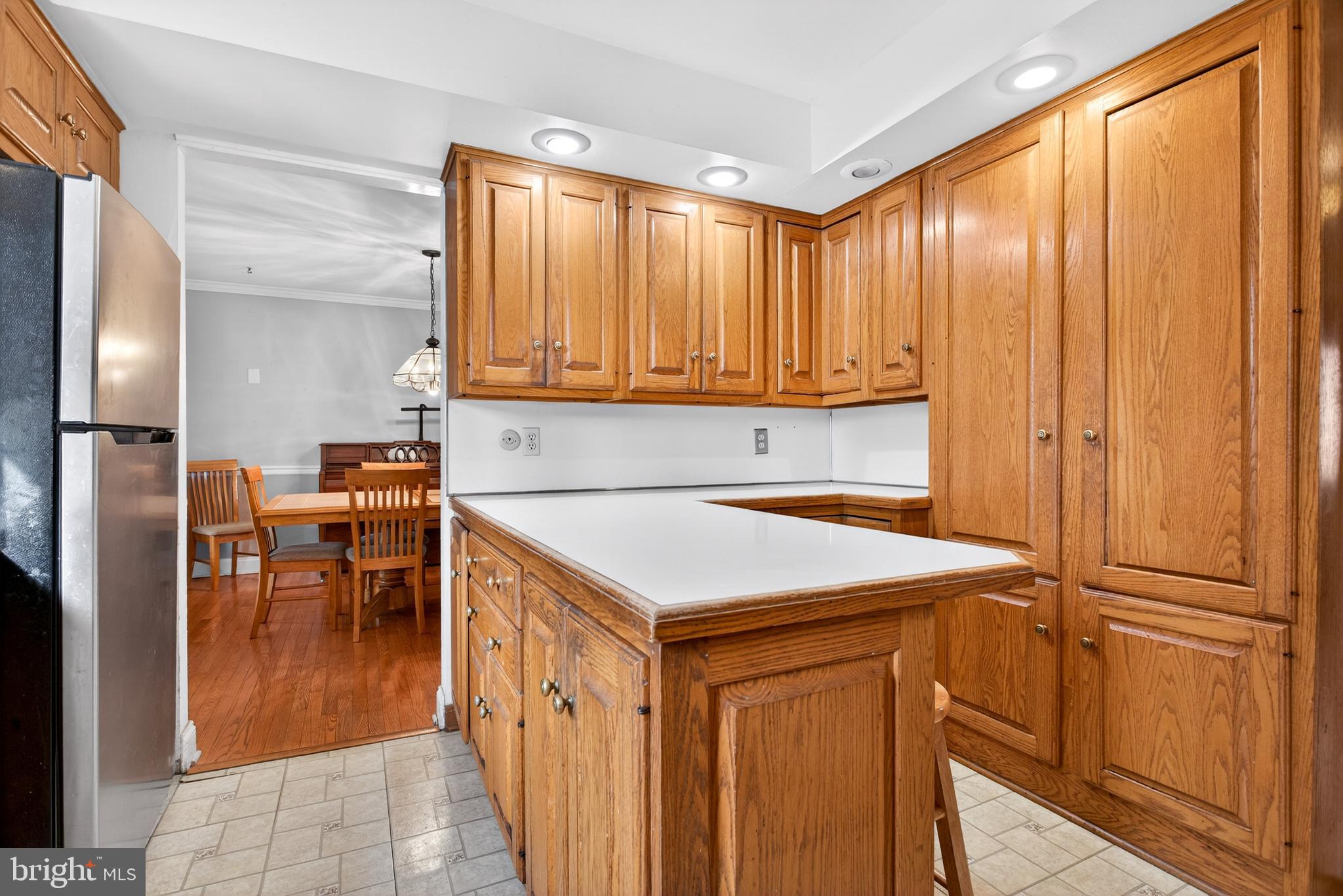 26 Austin Road Yardley, PA 19067 - Photo 7 of 33 a kitchen with a refrigerator a table and chairs