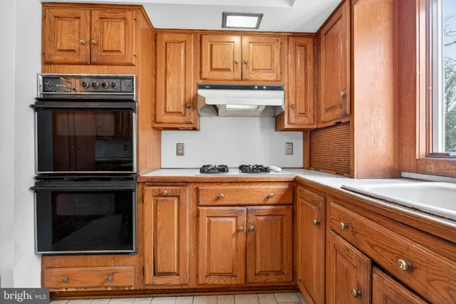 a kitchen with stainless steel appliances granite countertop a stove and cabinets