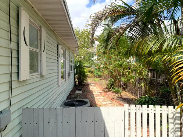 a view of a yard with wooden fence