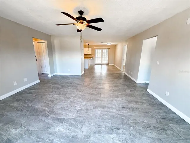 a view of a livingroom with a ceiling fan and window