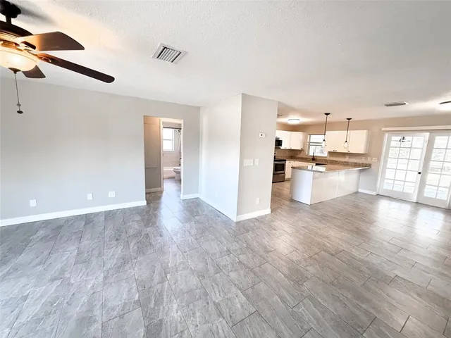 a view of a kitchen with a sink and dishwasher a refrigerator with wooden floor
