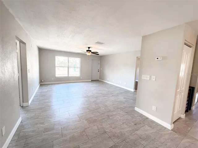 an empty room with windows and closet
