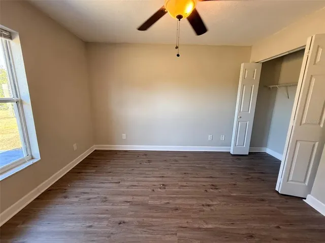 a view of an empty room and wooden floor