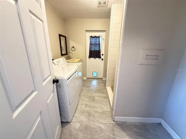 a view of a hallway view with wooden floor and staircase