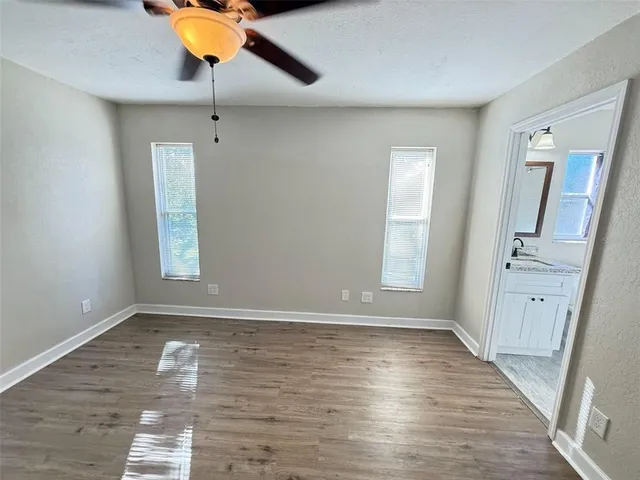 wooden floor in an empty room with a window