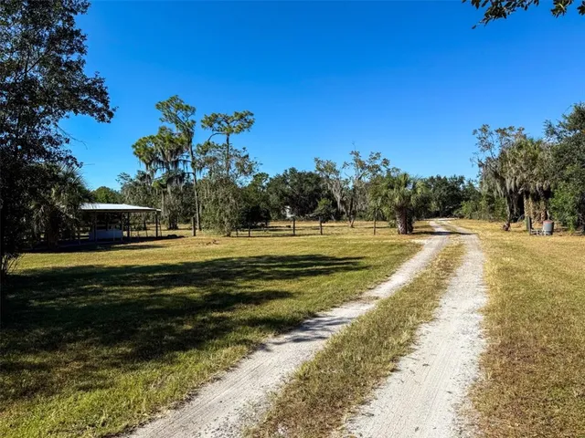 a view of a swimming pool with a house in the background