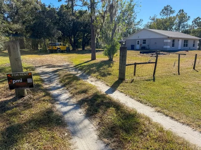 a view of yard with swimming pool and trees