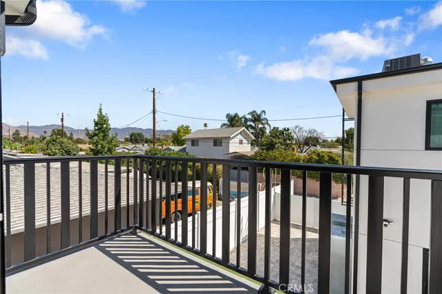 a view of a balcony with wooden fence