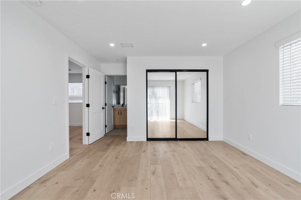 11140 Woodley Avenue, Unit 1/2 Granada Hills, CA 91344 - Photo 10 of 20 a view of an empty room with wooden floor and a window