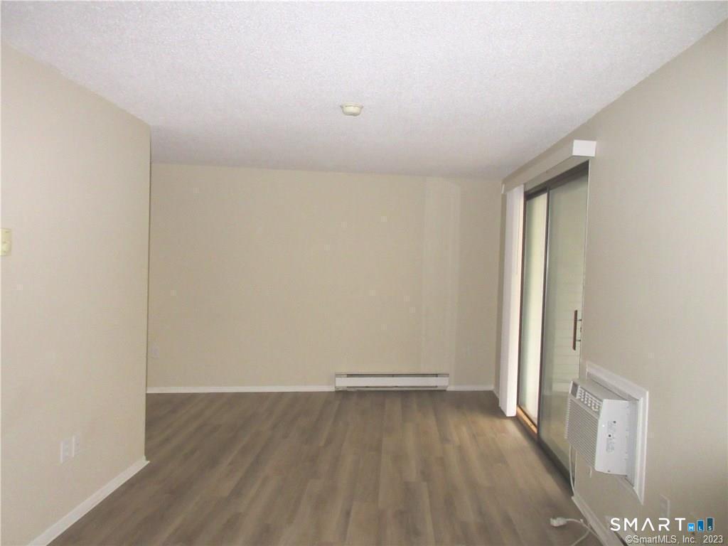 5 Nabby Road, Unit A51 Danbury, CT 06811 - Photo 3 of 13 an empty room with wooden floor and windows