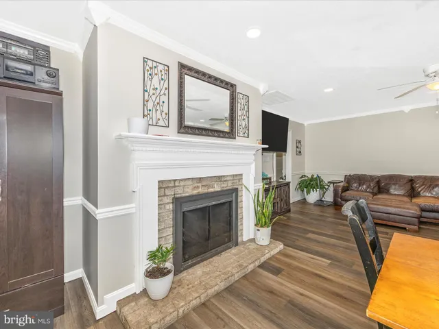 a kitchen with stainless steel appliances granite countertop a refrigerator a sink dishwasher a stove with wooden cabinets and a dining table