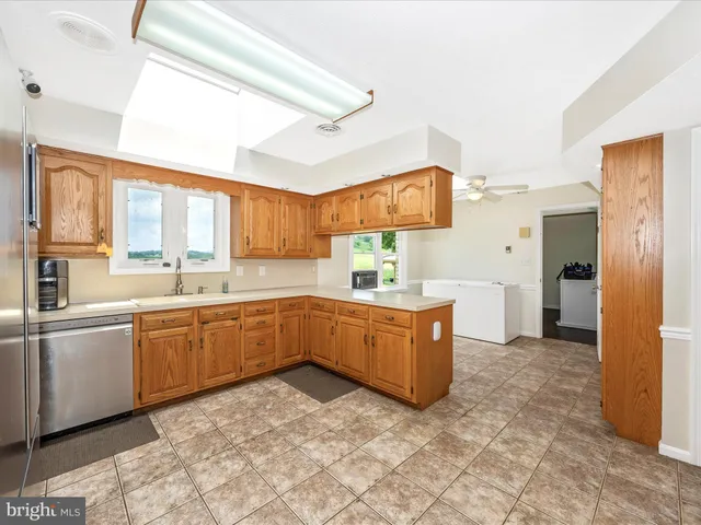 a kitchen with stainless steel appliances granite countertop a refrigerator sink and cabinets