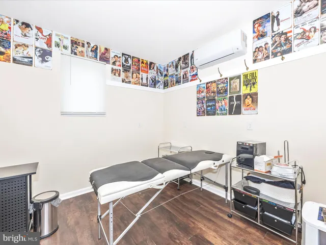 a living room with furniture a wooden floor and a dining table