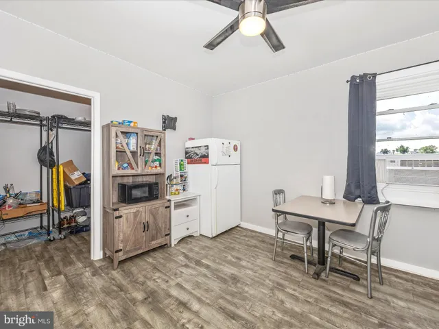a view of an house with pool and trees in the background