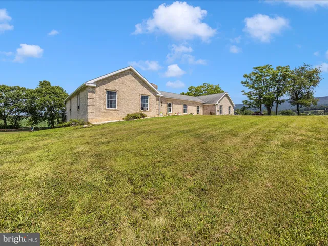 a view of house with backyard and outdoor seating