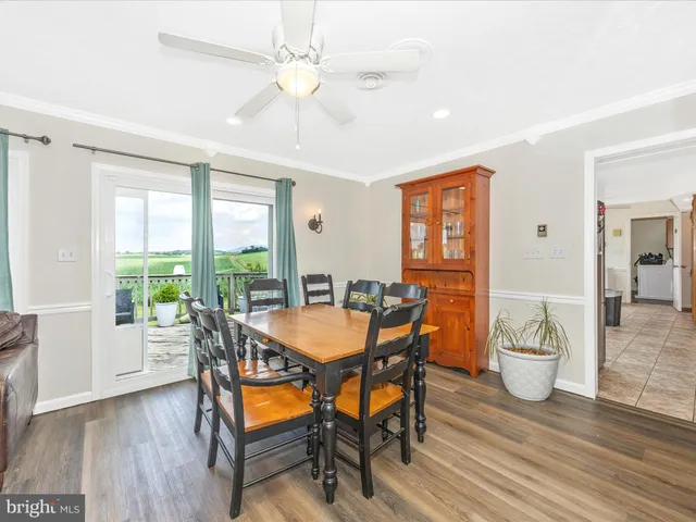 a dining room with furniture and wooden floor