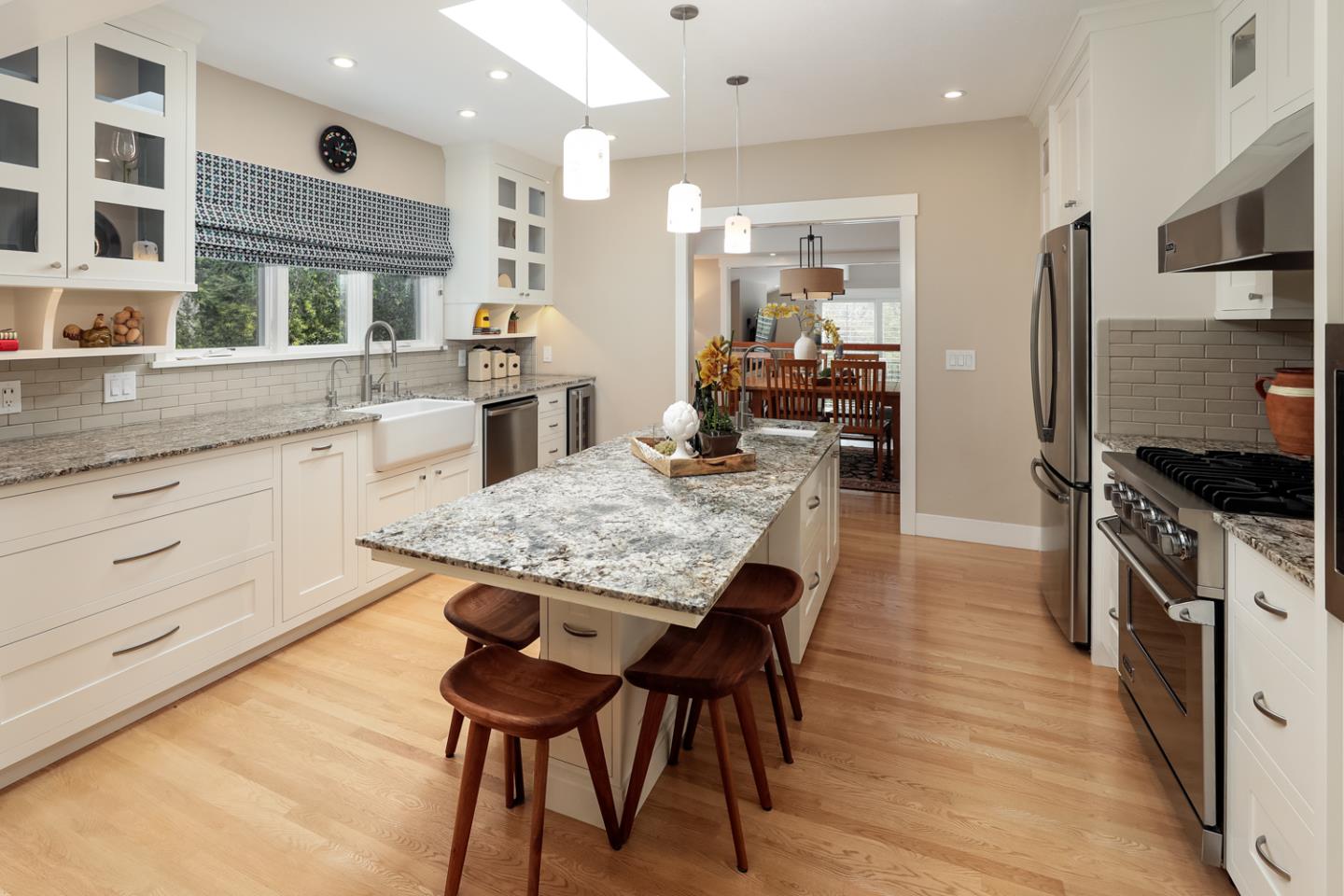 21781 Prospect Road Saratoga, CA 95070 - Photo 13 of 51 a kitchen with stainless steel appliances a dining table chairs stove refrigerator and cabinets