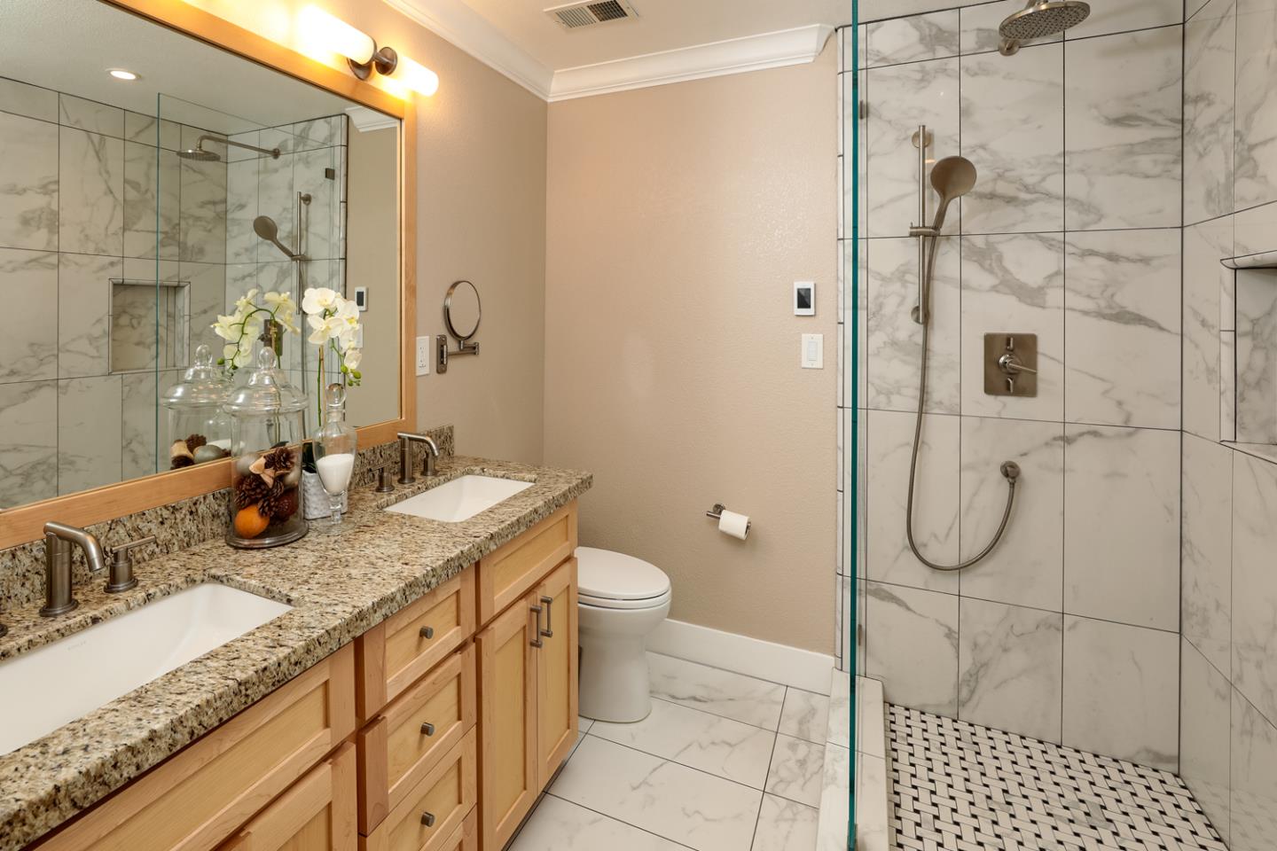 21781 Prospect Road Saratoga, CA 95070 - Photo 28 of 51 a bathroom with a granite countertop sink a toilet and shower