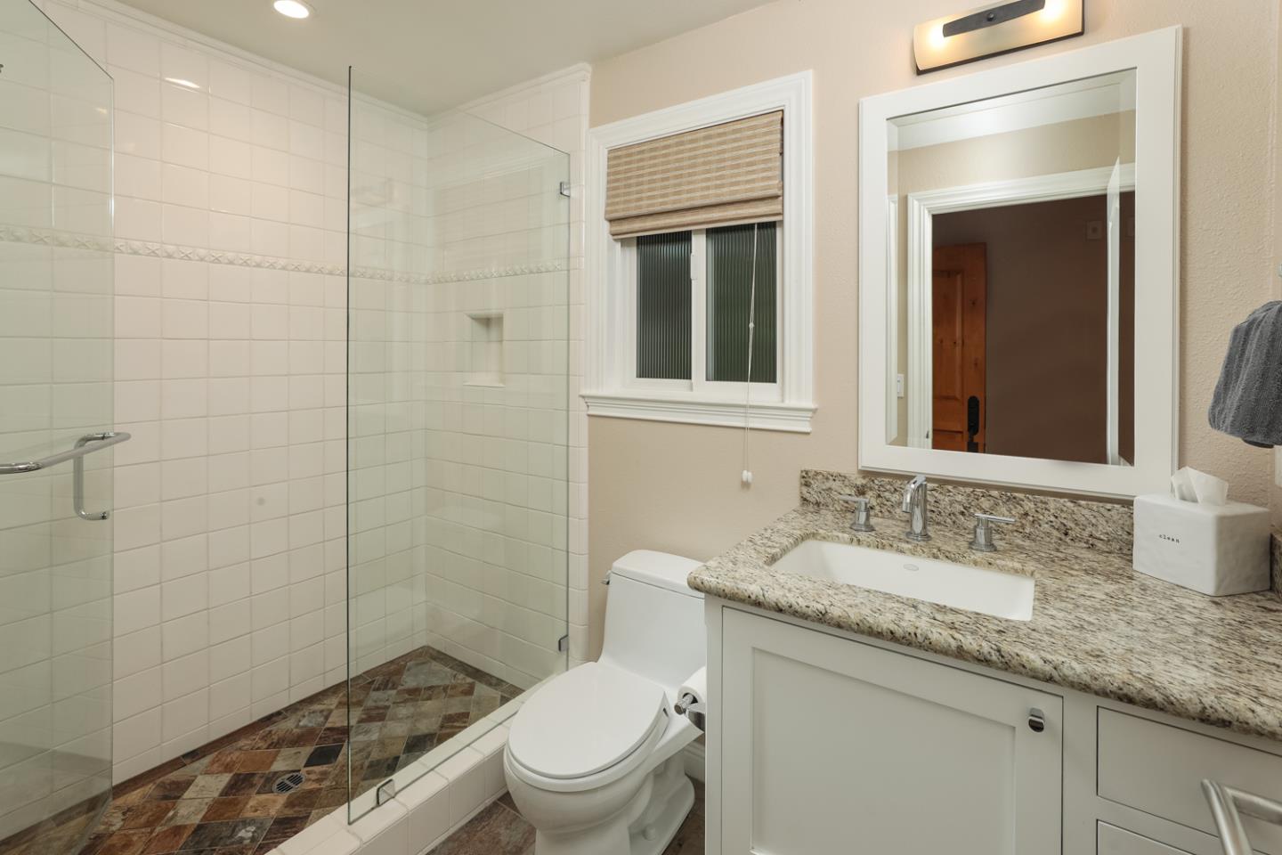 21781 Prospect Road Saratoga, CA 95070 - Photo 37 of 51 a bathroom with a granite countertop sink a toilet and shower