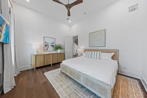 an aerial view of residential houses with outdoor space and trees