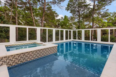 a kitchen with stainless steel appliances granite countertop a stove and a refrigerator with white cabinets