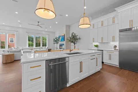 a spacious bedroom with a large bed a chandelier and a couch