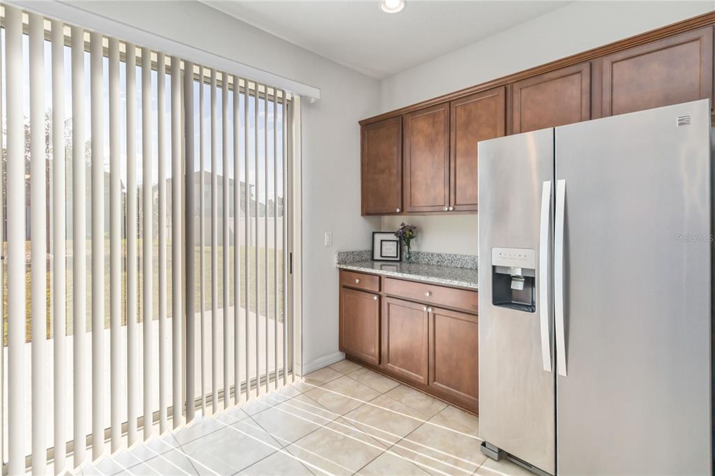 3566 Southern Cross Loop Kissimmee, FL 34744 - Photo 13 of 32 a kitchen with stainless steel appliances a refrigerator and a sink