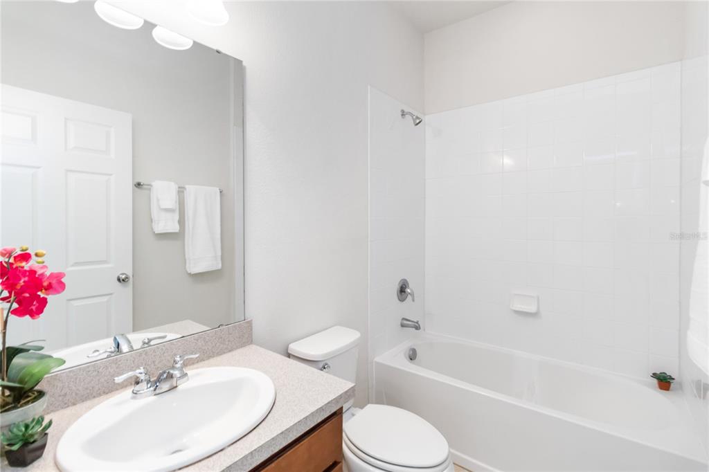 3566 Southern Cross Loop Kissimmee, FL 34744 - Photo 14 of 32 a bathroom with a sink toilet and shower