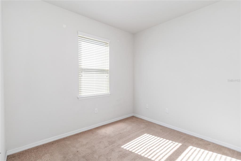 3566 Southern Cross Loop Kissimmee, FL 34744 - Photo 15 of 32 an empty room with windows