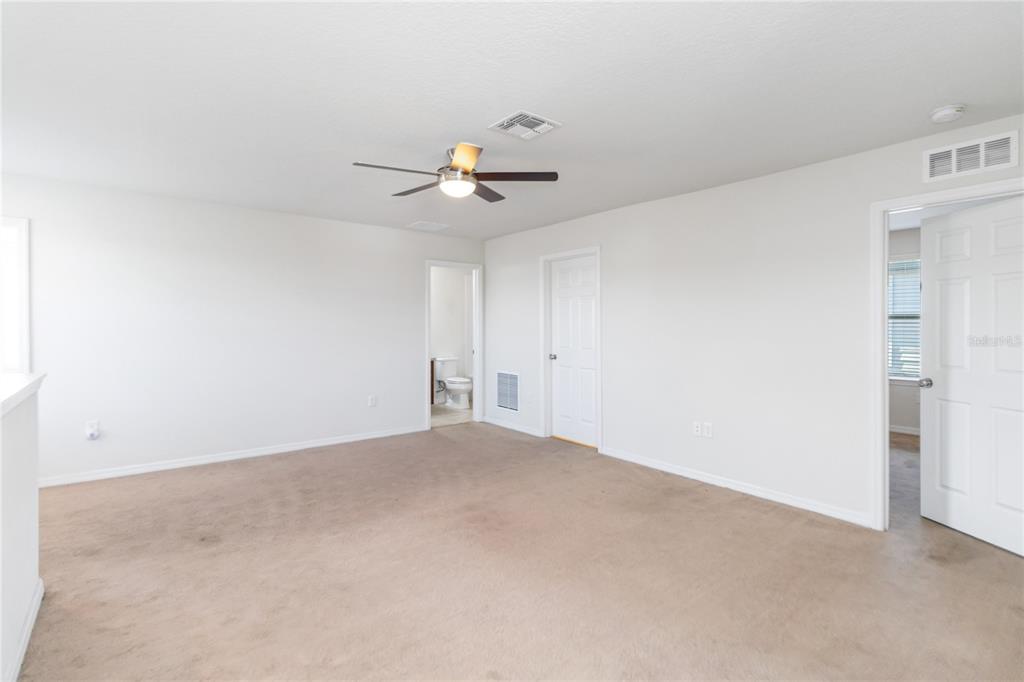 3566 Southern Cross Loop Kissimmee, FL 34744 - Photo 19 of 32 a view of an empty room with a ceiling fan