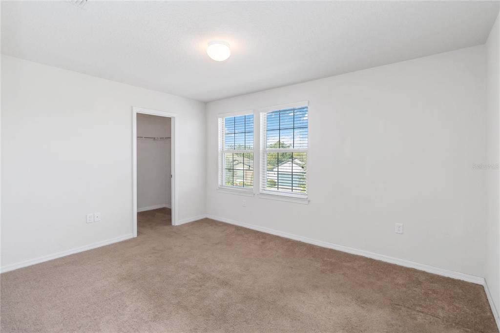 3566 Southern Cross Loop Kissimmee, FL 34744 - Photo 23 of 32 an empty room with windows