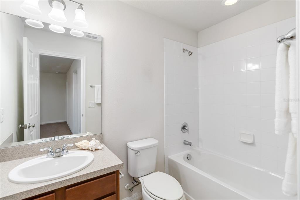 3566 Southern Cross Loop Kissimmee, FL 34744 - Photo 26 of 32 a bathroom with a sink toilet tub and shower