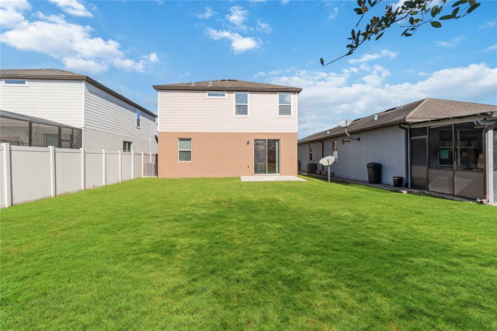 3566 Southern Cross Loop Kissimmee, FL 34744 - Photo 29 of 32 a front view of house with yard and green space