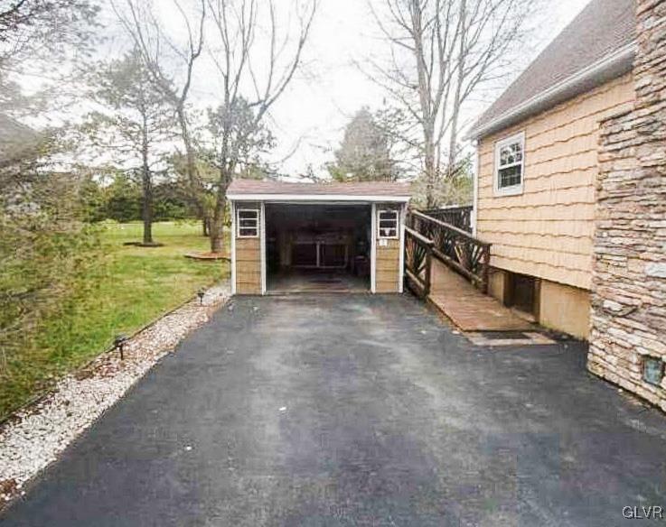 124 Bull Run Long Pond, PA 18334 - Photo 4 of 13 a view of a house with a yard and garage