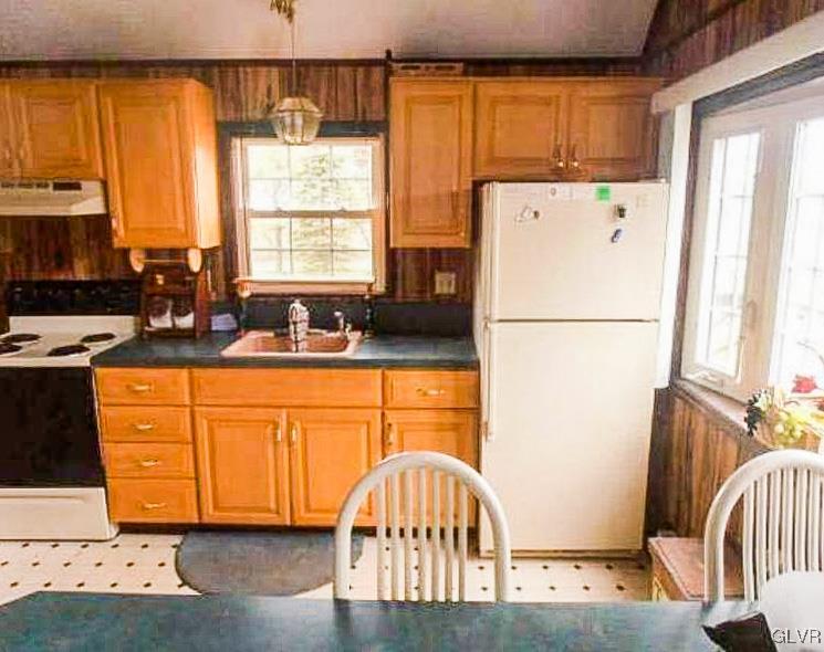 124 Bull Run Long Pond, PA 18334 - Photo 10 of 13 a kitchen with stainless steel appliances granite countertop a refrigerator a stove a sink dishwasher and wooden cabinets