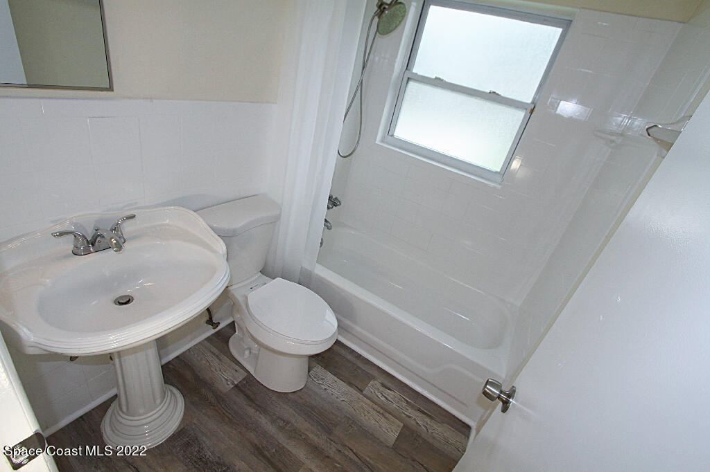 114 1st Street Merritt Island, FL 32953 - Photo 12 of 21 a white toilet sitting next to a bathroom sink