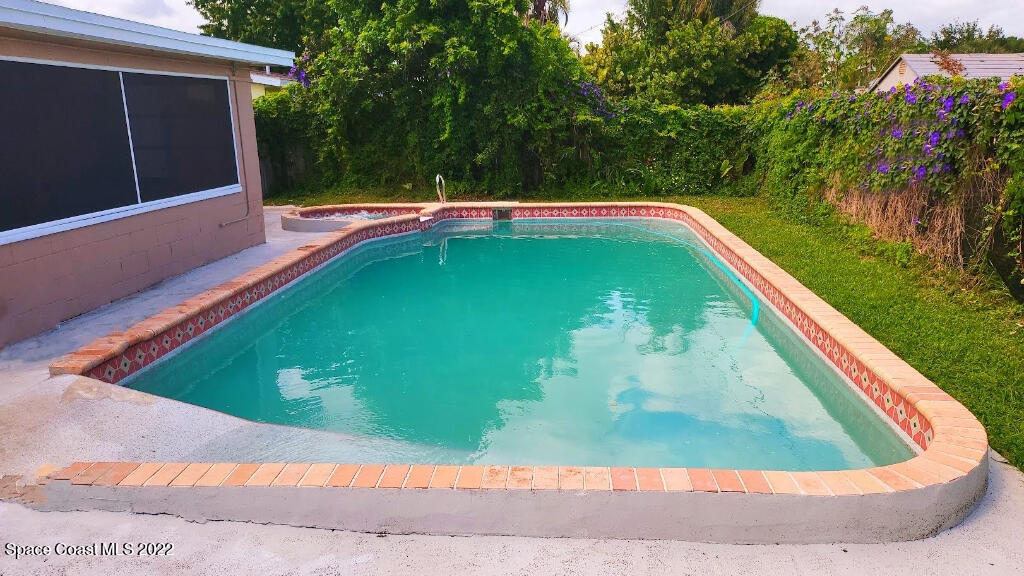 114 1st Street Merritt Island, FL 32953 - Photo 20 of 21 a view of a pool in a backyard