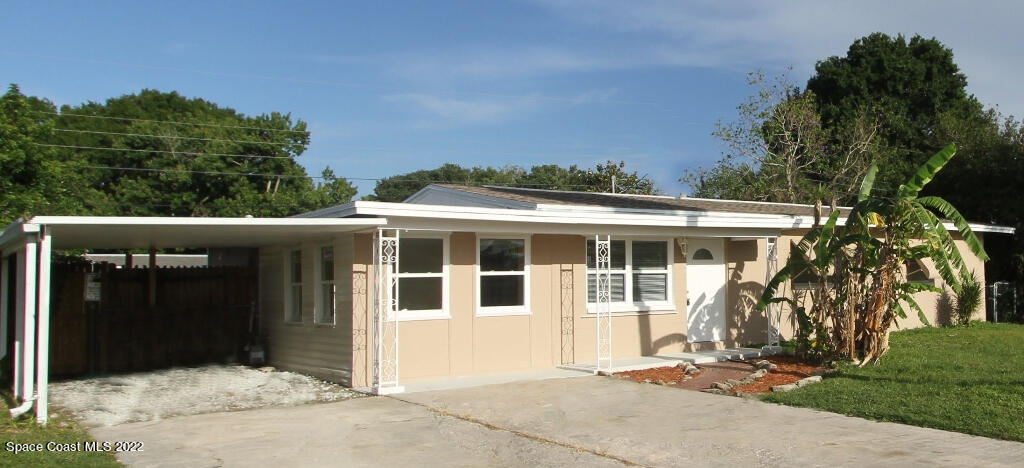 114 1st Street Merritt Island, FL 32953 - Photo 3 of 21 a front view of a house with a garden