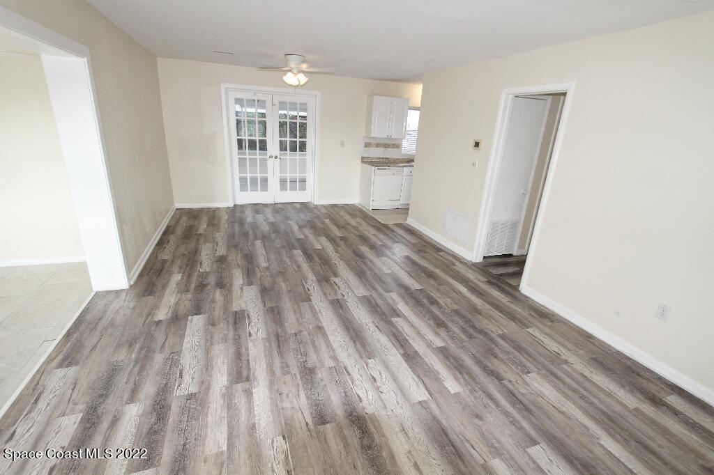 114 1st Street Merritt Island, FL 32953 - Photo 4 of 21 wooden floor in an empty room with a window