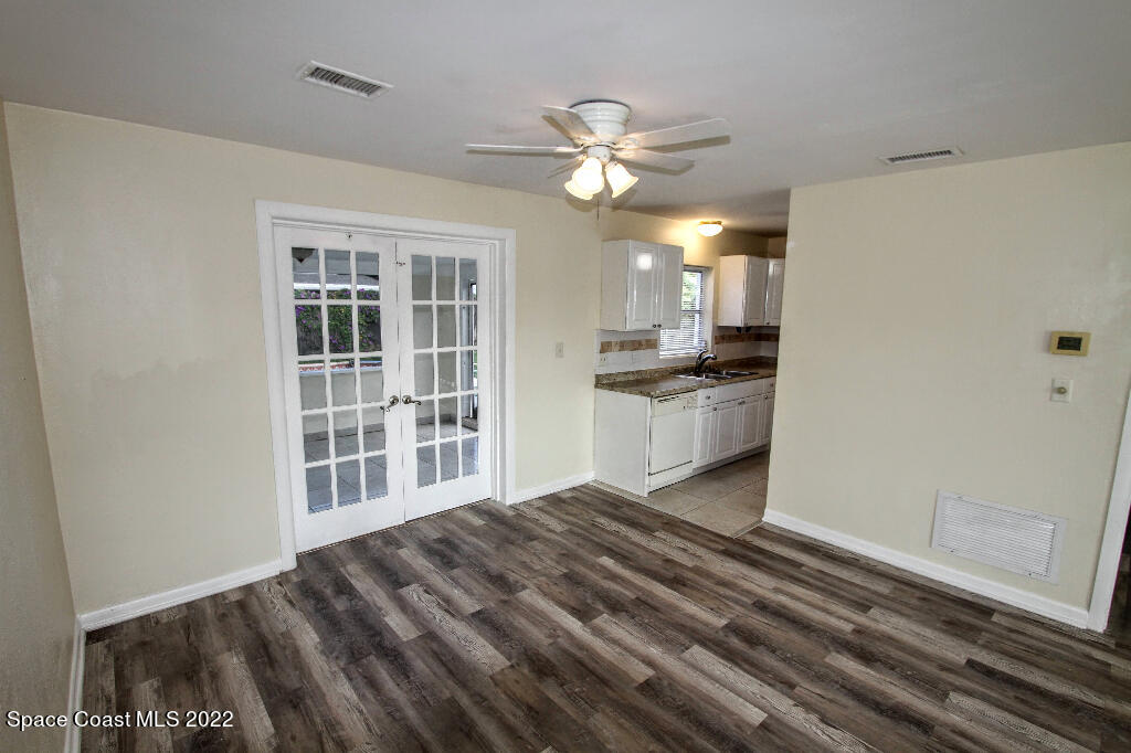 114 1st Street Merritt Island, FL 32953 - Photo 8 of 21 a view of a kitchen with a sink dishwasher and wooden floor